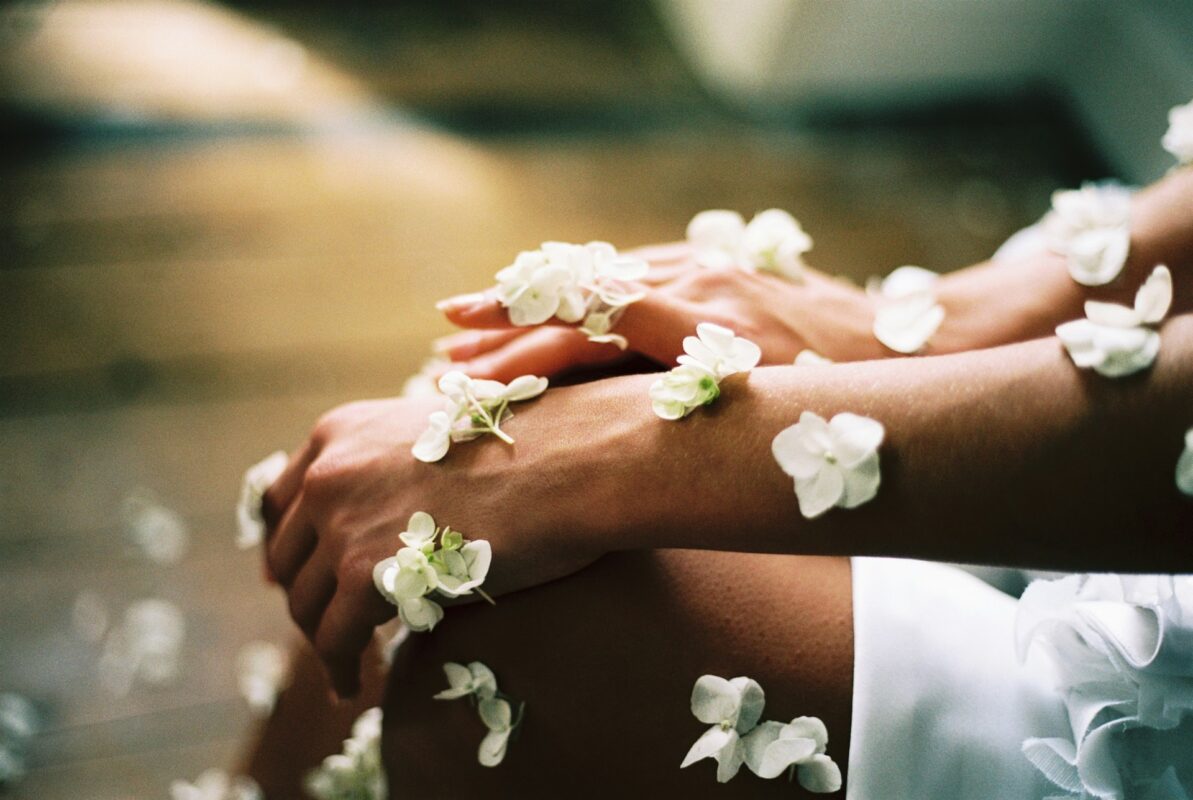 A person surrounded by white flowers. 